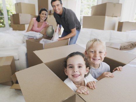 Professional removal team handling household moving boxes in Maidavale