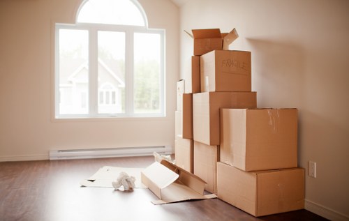 Professional movers carrying furniture during a same day removal