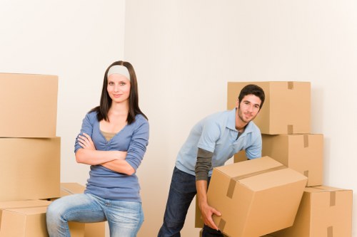 Local Maidavale moving team packing household items carefully into boxes