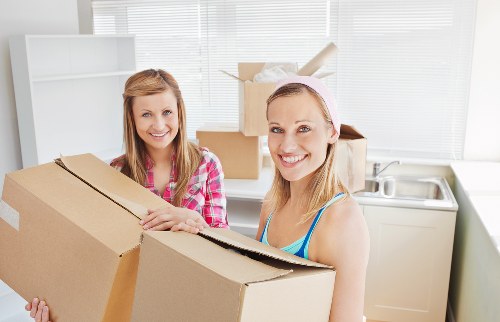 Local furniture movers handling heavy items with protective equipment